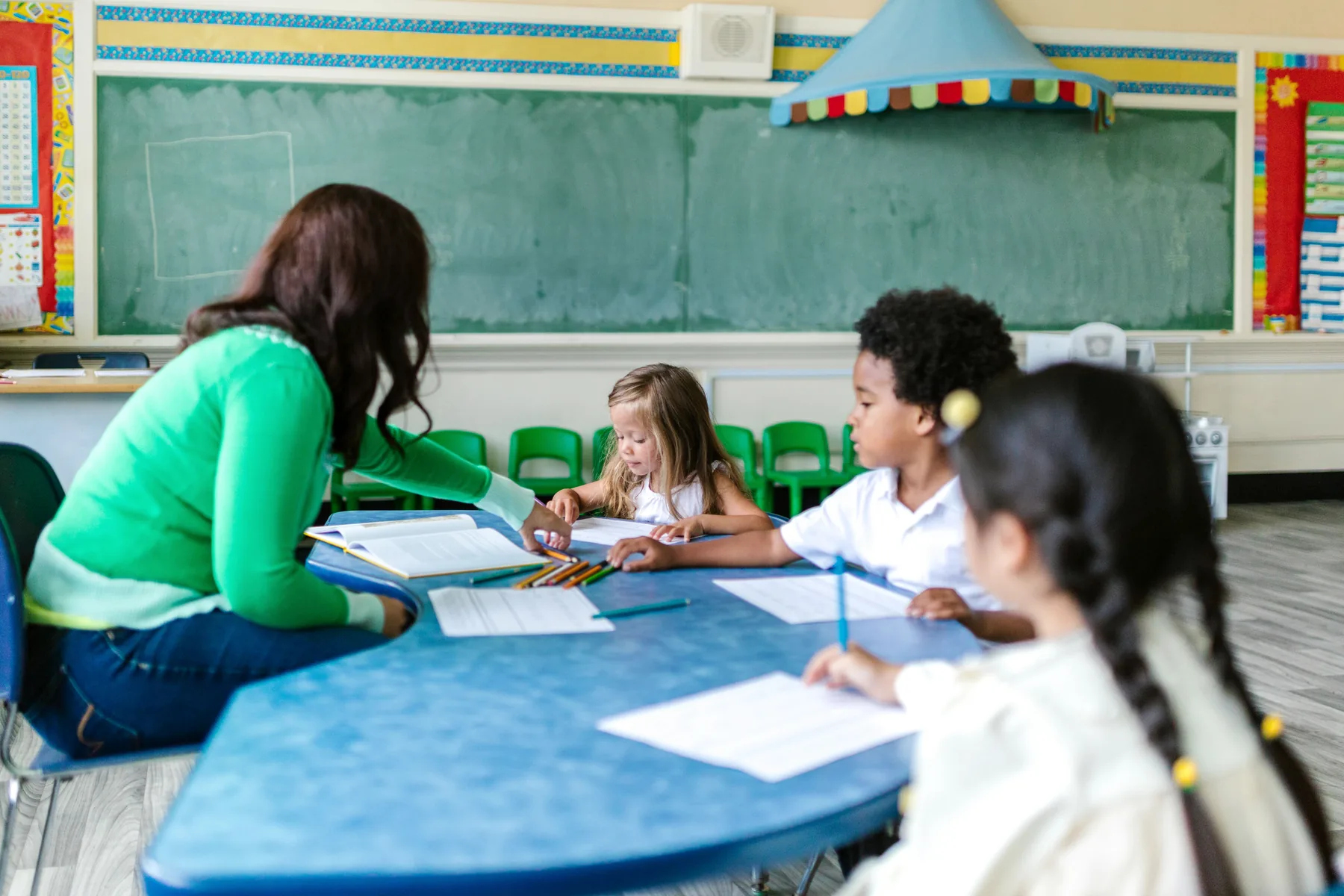 Children learning together with a teacher in a welcoming classroom